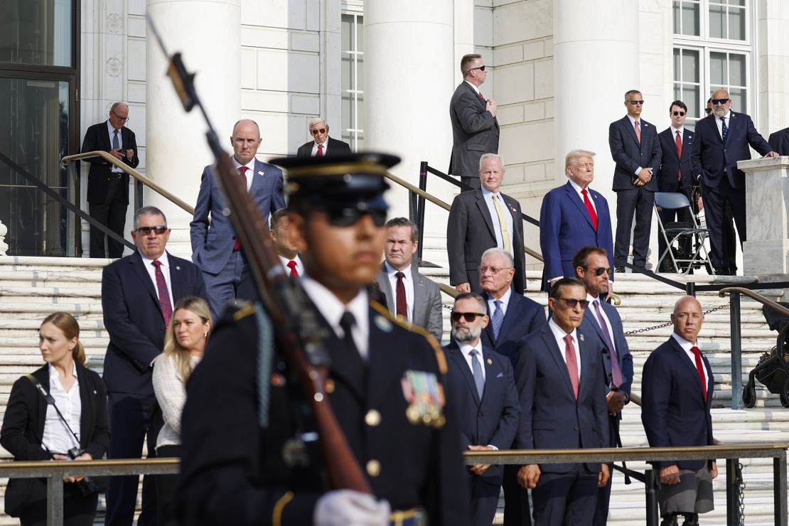 Former President Donald Trump watches the changing of the guard at the Tomb of the Unknown Soldier near Arlington National Cemetery Deputy Chief of Staff Bob Quackenbush at Arlington National Cemetery on August 26, 2024 in Arlington, Virginia.